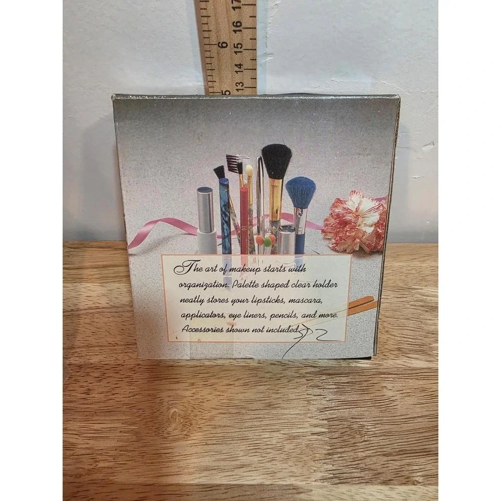 1990s NOS clear acrylic makeup organizer featuring tiered slots for holding